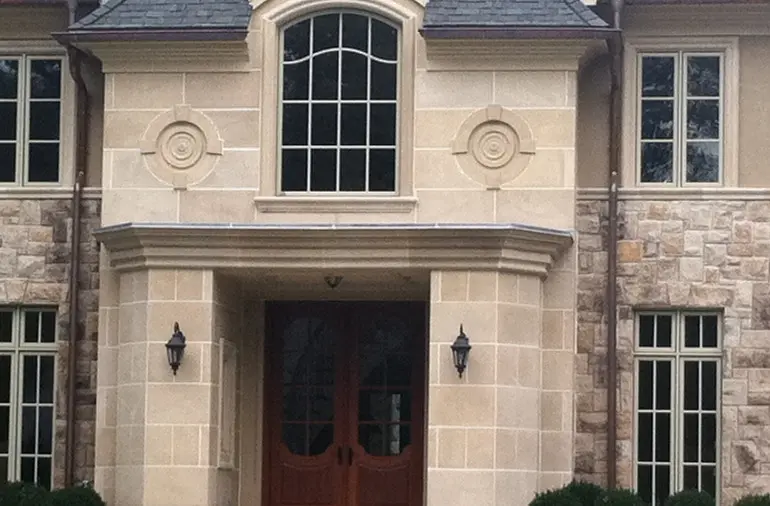 two story tan house with stucco exterior
